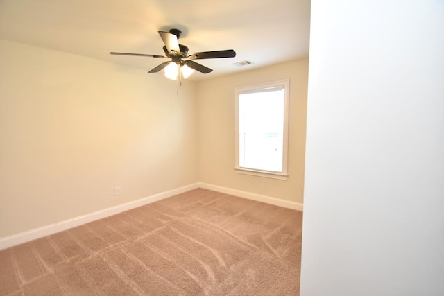 carpeted spare room with ceiling fan