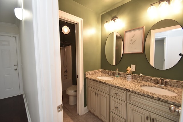 bathroom with toilet, vanity, tile patterned flooring, and a shower