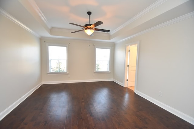 spare room with ornamental molding, dark hardwood / wood-style flooring, and a raised ceiling