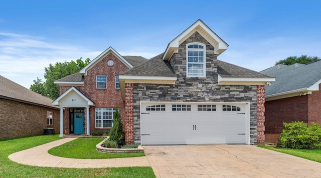 front facade featuring central AC and a garage