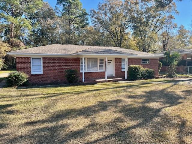 ranch-style home with a front lawn