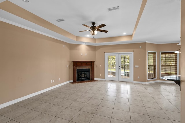 170 County Road 751, Enterprise, AL 36330 - unfurnished living room featuring ceiling fan, light tile patterned floors, a raised ceiling, french doors, and a tile fireplace