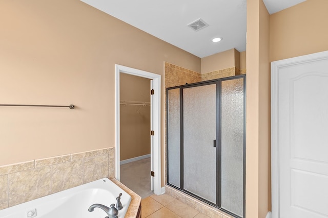 170 County Road 751, Enterprise, AL 36330 - bathroom featuring a shower stall, a garden tub, tile patterned flooring, and a walk in closet