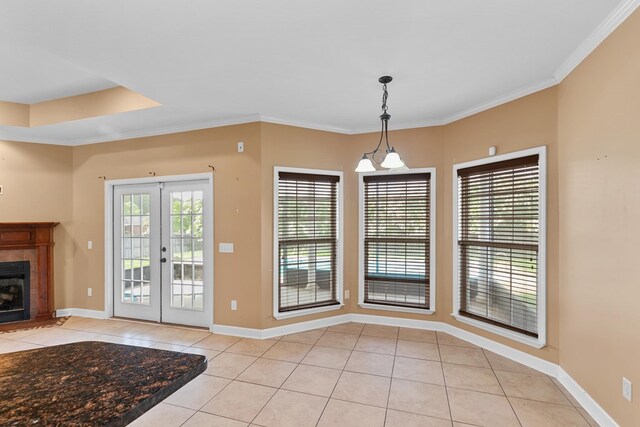 170 County Road 751, Enterprise, AL 36330 - unfurnished dining area featuring light tile patterned flooring, french doors, ornamental molding, and a fireplace