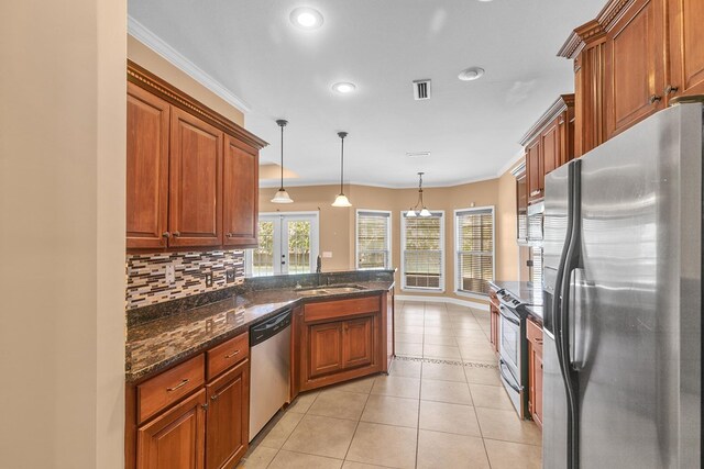170 County Road 751, Enterprise, AL 36330 - kitchen featuring stainless steel appliances, tasteful backsplash, recessed lighting, brown cabinetry, and crown molding