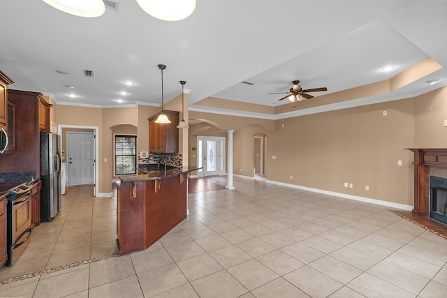 170 County Road 751, Enterprise, AL 36330 - kitchen with ornate columns, stainless steel appliances, arched walkways, light tile patterned floors, and decorative backsplash
