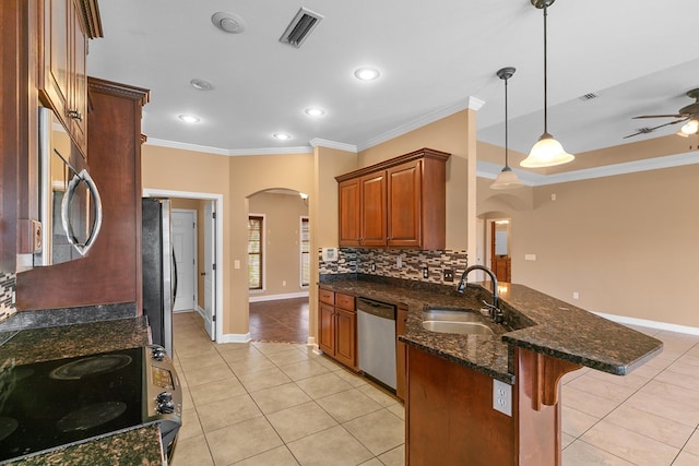 170 County Road 751, Enterprise, AL 36330 - kitchen with arched walkways, stainless steel appliances, crown molding, a peninsula, and light tile patterned floors
