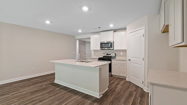 kitchen featuring dark hardwood / wood-style flooring, stainless steel appliances, sink, white cabinets, and an island with sink