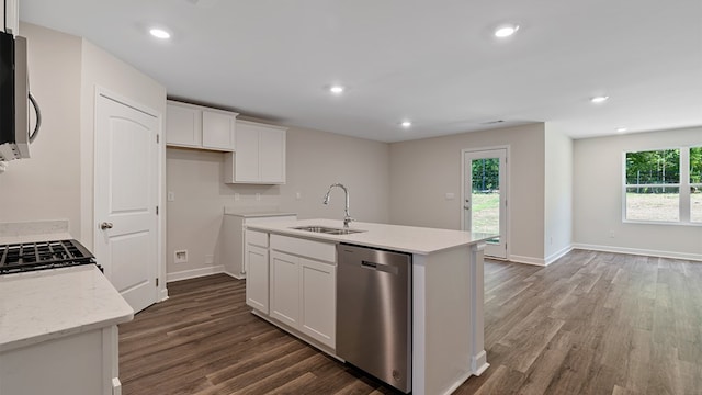 kitchen with dishwasher, sink, white cabinetry, and an island with sink