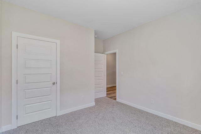 unfurnished bedroom featuring carpet flooring and a closet