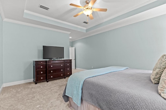 bedroom featuring a raised ceiling, light colored carpet, and visible vents