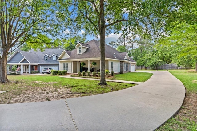 cape cod home featuring a garage, a front lawn, fence, and driveway
