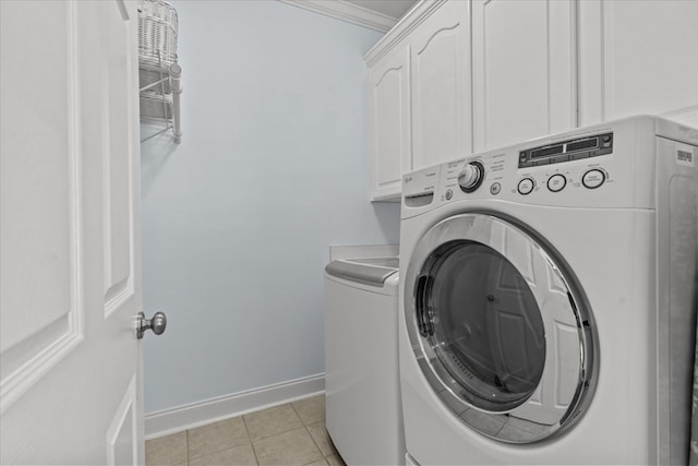 laundry area with washer and dryer, crown molding, cabinet space, baseboards, and light tile patterned floors