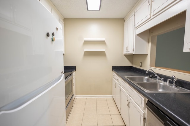 kitchen with white cabinetry, sink, light tile patterned floors, and appliances with stainless steel finishes