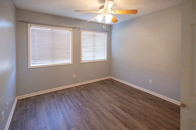 unfurnished room with a textured ceiling, dark hardwood / wood-style flooring, and ceiling fan