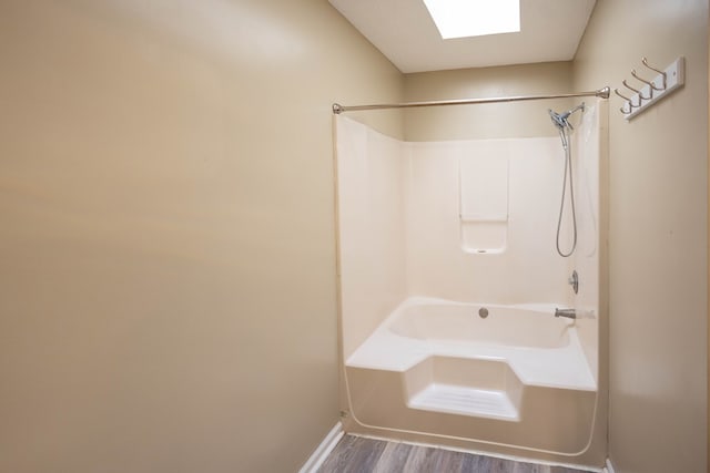 bathroom featuring wood-type flooring and shower / bathtub combination