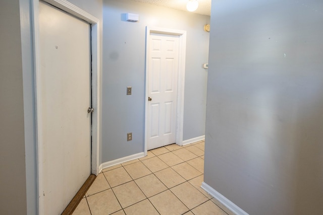 hall featuring light tile patterned floors