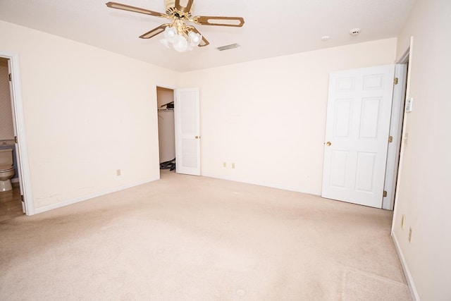 unfurnished bedroom with light carpet, visible vents, baseboards, and ensuite bathroom