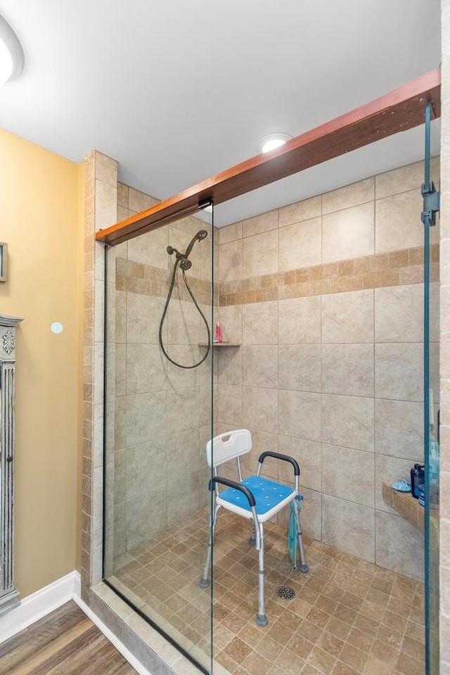 bathroom featuring wood-type flooring and a shower with door