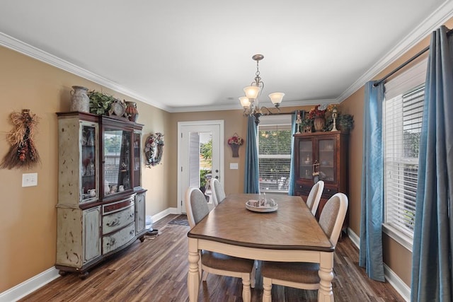 dining space with crown molding, dark hardwood / wood-style flooring, and a chandelier