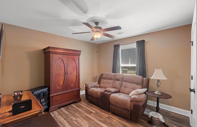 living room featuring hardwood / wood-style floors and ceiling fan