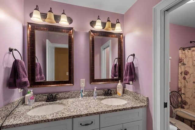 bathroom featuring a shower with curtain and vanity