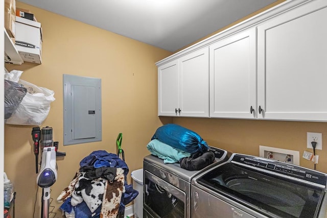 laundry room with electric panel, cabinets, and washing machine and dryer