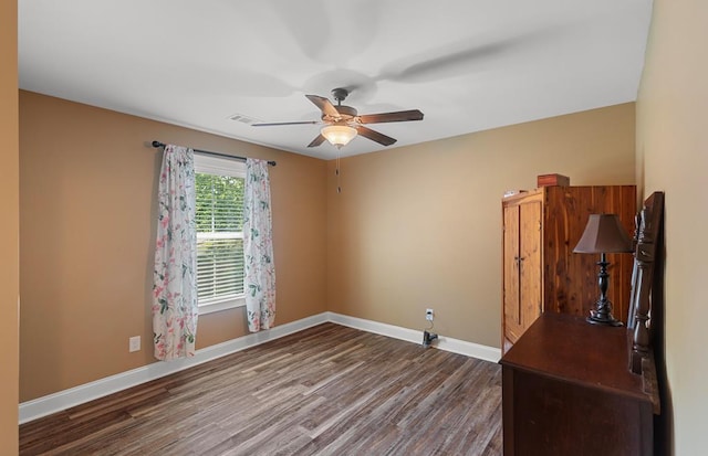 spare room featuring hardwood / wood-style floors and ceiling fan