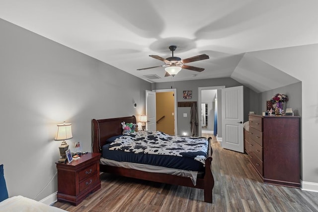 bedroom featuring ceiling fan, dark hardwood / wood-style flooring, and vaulted ceiling