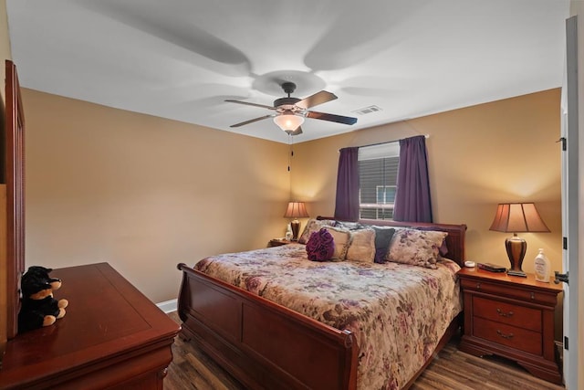 bedroom with dark hardwood / wood-style floors and ceiling fan