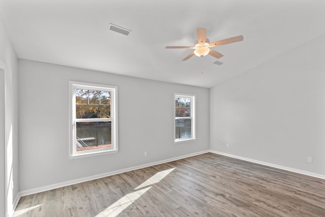 spare room featuring light hardwood / wood-style floors, plenty of natural light, and ceiling fan