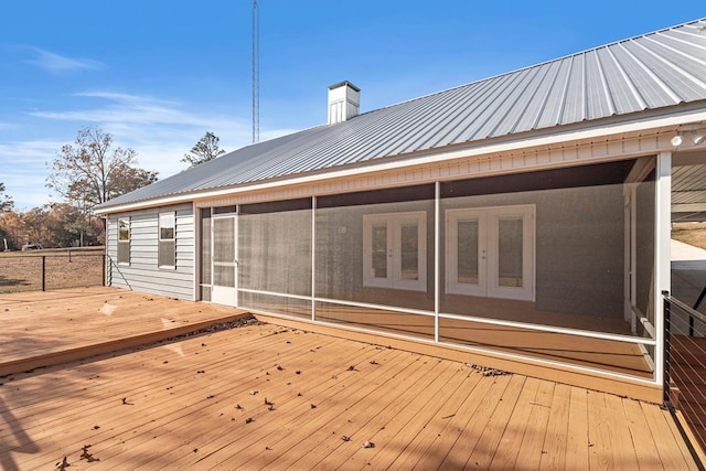 deck with french doors and a sunroom