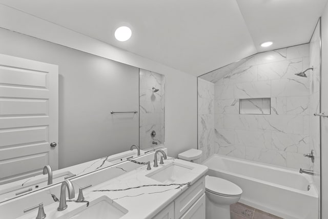 full bathroom with vanity, tiled shower / bath combo, tile patterned flooring, toilet, and lofted ceiling