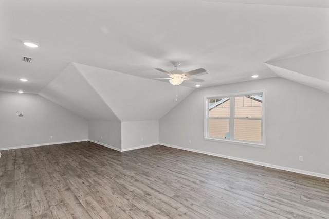 bonus room with wood-type flooring, vaulted ceiling, and ceiling fan