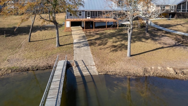 rear view of property with a deck with water view