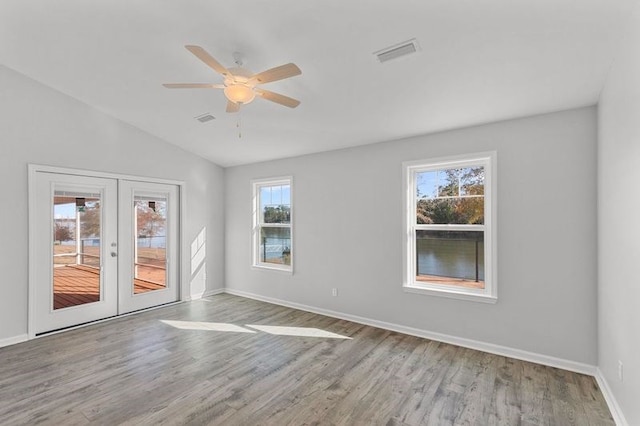 unfurnished room with hardwood / wood-style floors, a healthy amount of sunlight, and french doors