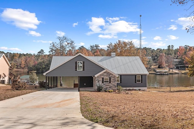 view of front of house with a carport and a water view