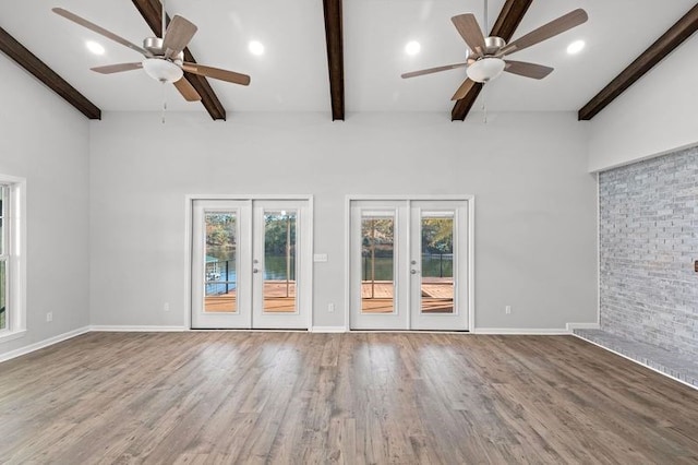 unfurnished living room featuring french doors, hardwood / wood-style flooring, and ceiling fan