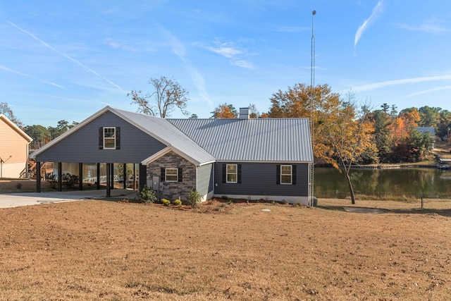 view of front of house with a carport and a water view