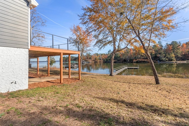 view of yard featuring a water view and a dock