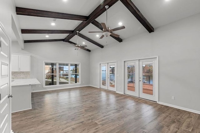 unfurnished living room with french doors, dark hardwood / wood-style floors, a wealth of natural light, and ceiling fan