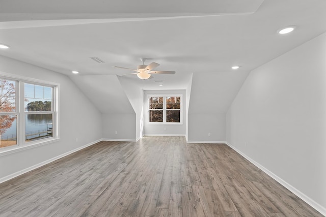 additional living space with light hardwood / wood-style flooring, ceiling fan, and lofted ceiling