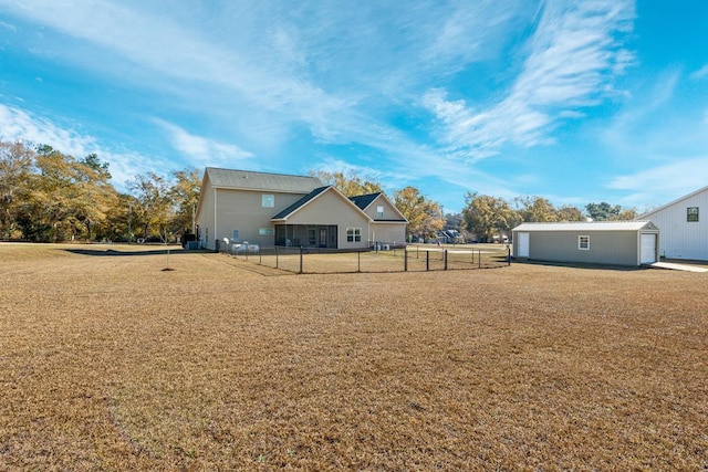 view of yard featuring a garage and an outdoor structure