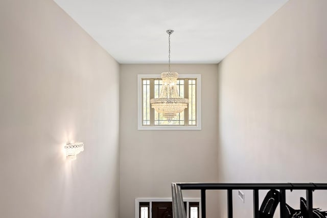 staircase featuring a chandelier