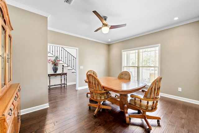 dining space with ceiling fan, dark wood-type flooring, and ornamental molding