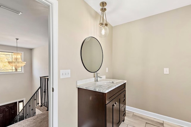 bathroom with a chandelier and vanity