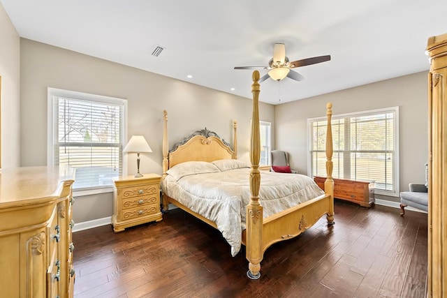 bedroom with ceiling fan, dark hardwood / wood-style floors, and multiple windows