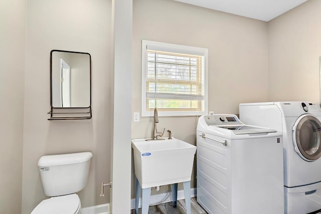 laundry area with washer and clothes dryer and sink