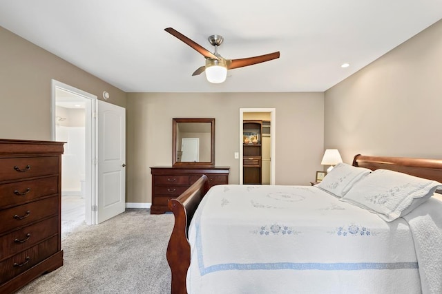 carpeted bedroom with a walk in closet, a closet, and ceiling fan