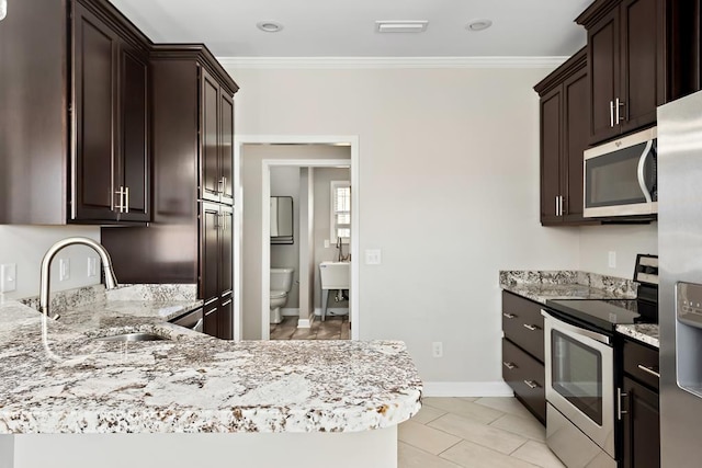 kitchen featuring crown molding, sink, dark brown cabinetry, and stainless steel appliances